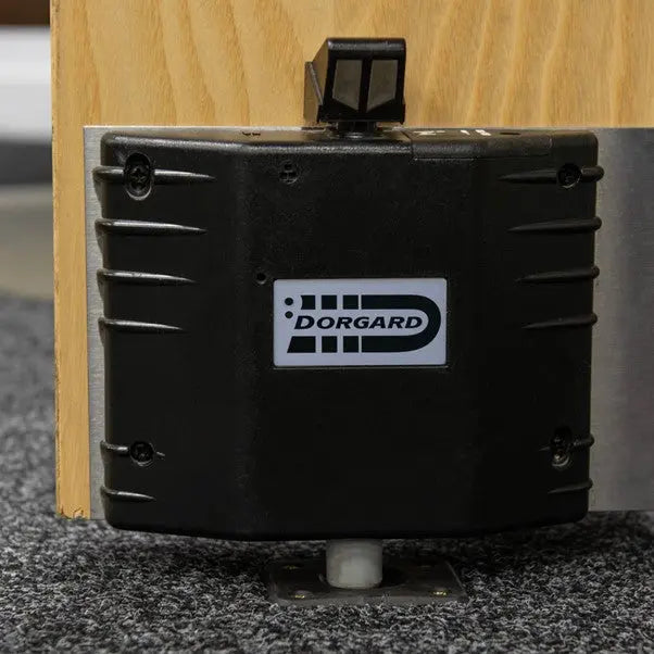 Black Dorgard security device attached to a wooden surface