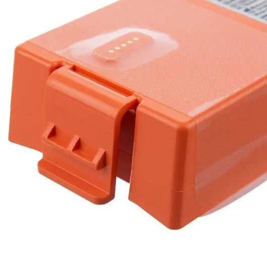 Close-up of an orange electronic device with a clear cover on a white background