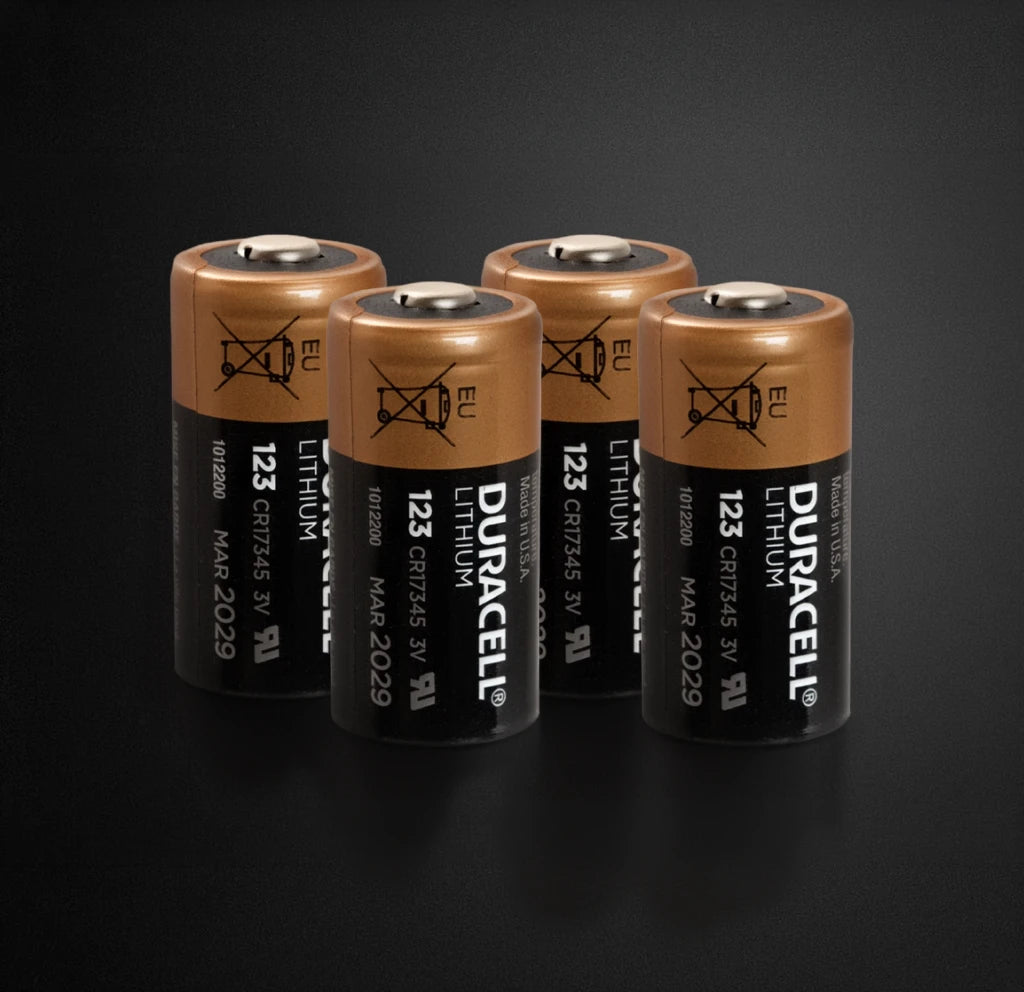 Four Duracell lithium batteries on a black background