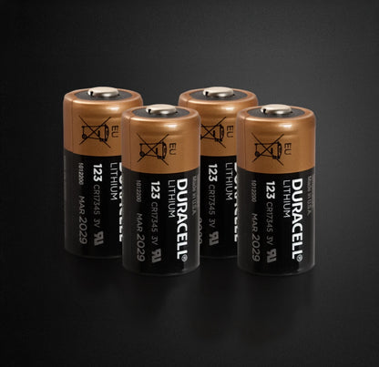 Four Duracell lithium batteries on a black background