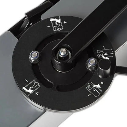 Close-up of a mechanical device with black and silver components on a white background